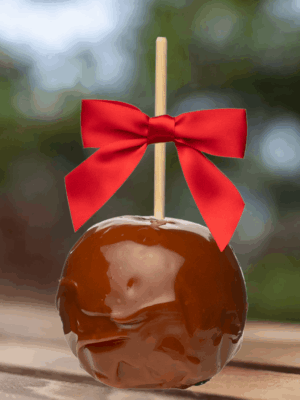 caramel apple with a red bow
